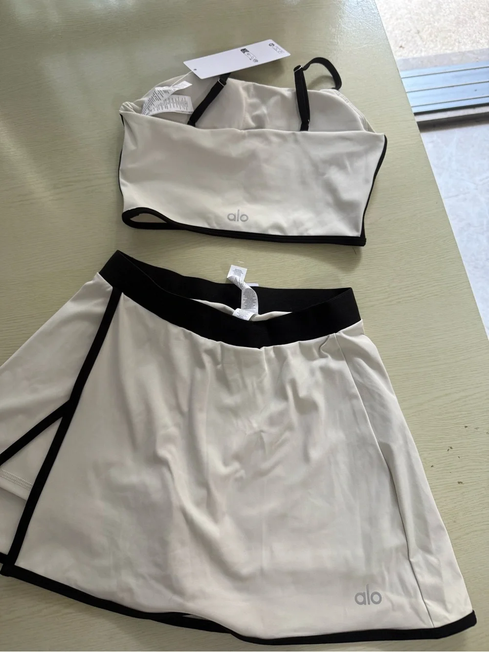 ALO Yoga Cream Sports Bra and Skort with Black Trim - Picture 2 of 6